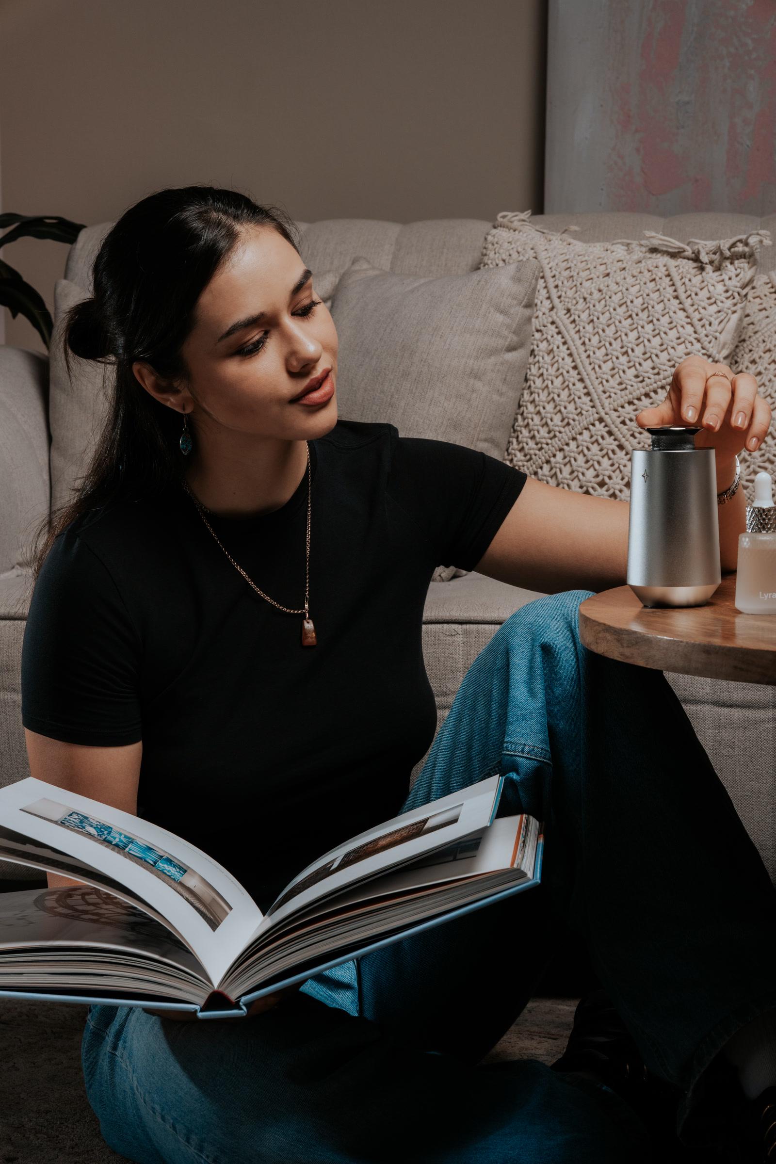 Vessel 01 beside a reader on the sofa